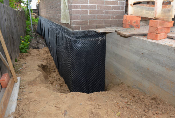 Happy homeowners after waterproofing job in Holly